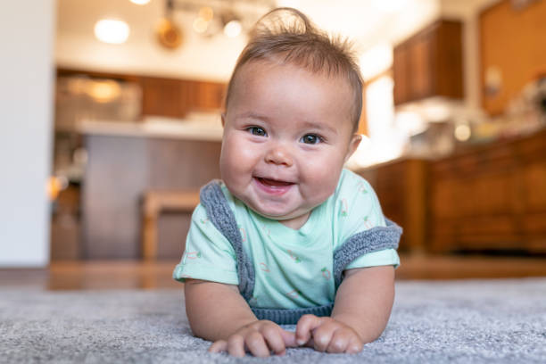 Cute baby laying on carpet floor | Bay Country Floors